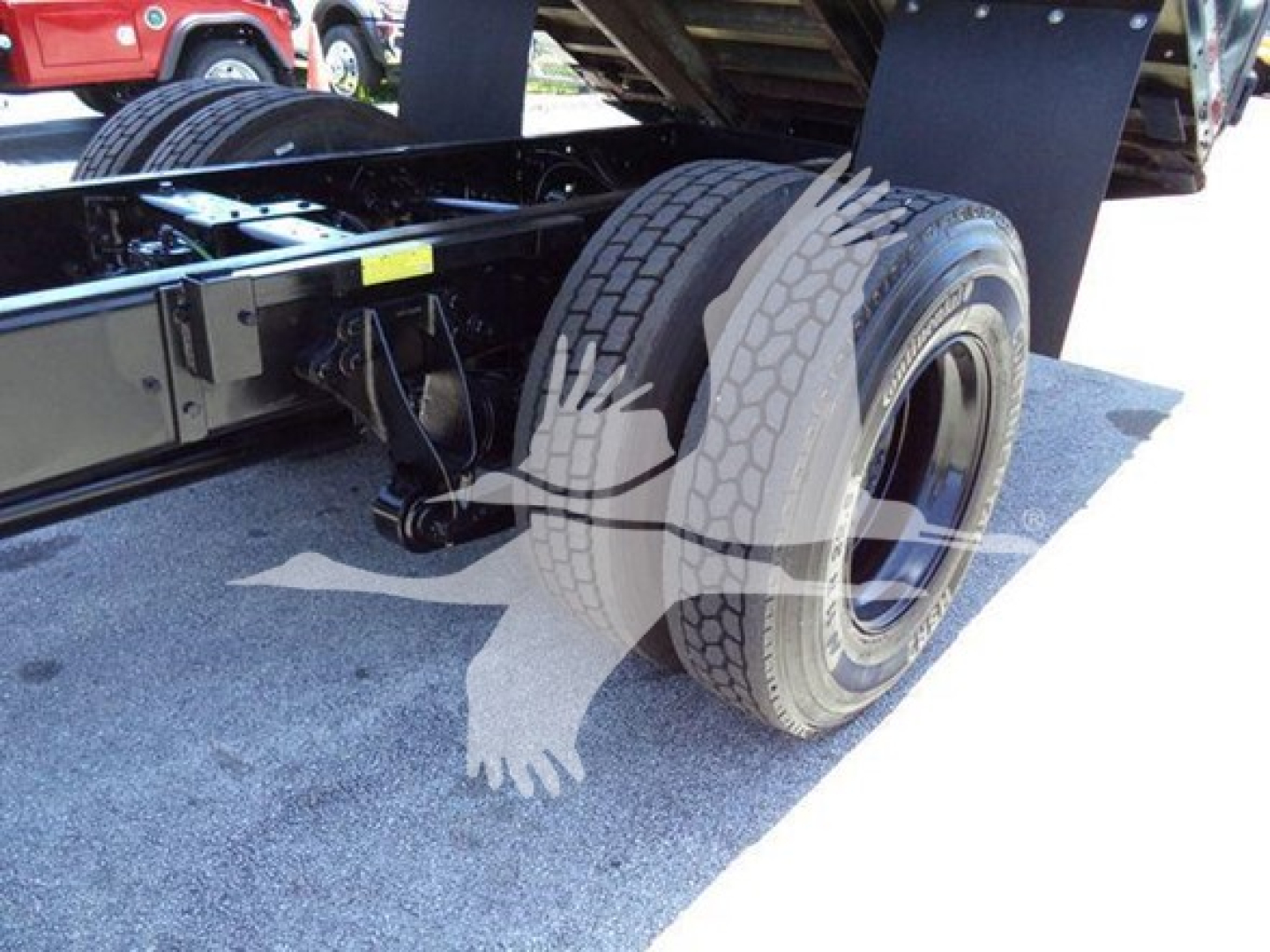 Truck chassis and dual rear tires of a 2019 International Durastar 4300 chassis showing wheel assembly and undercarriage components.