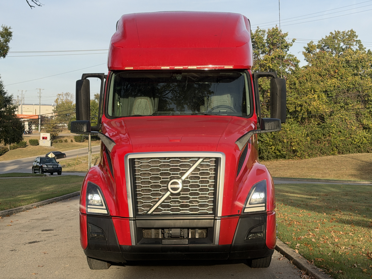 Volvo VNL truck with large grille and Volvo emblem; front view in red color.