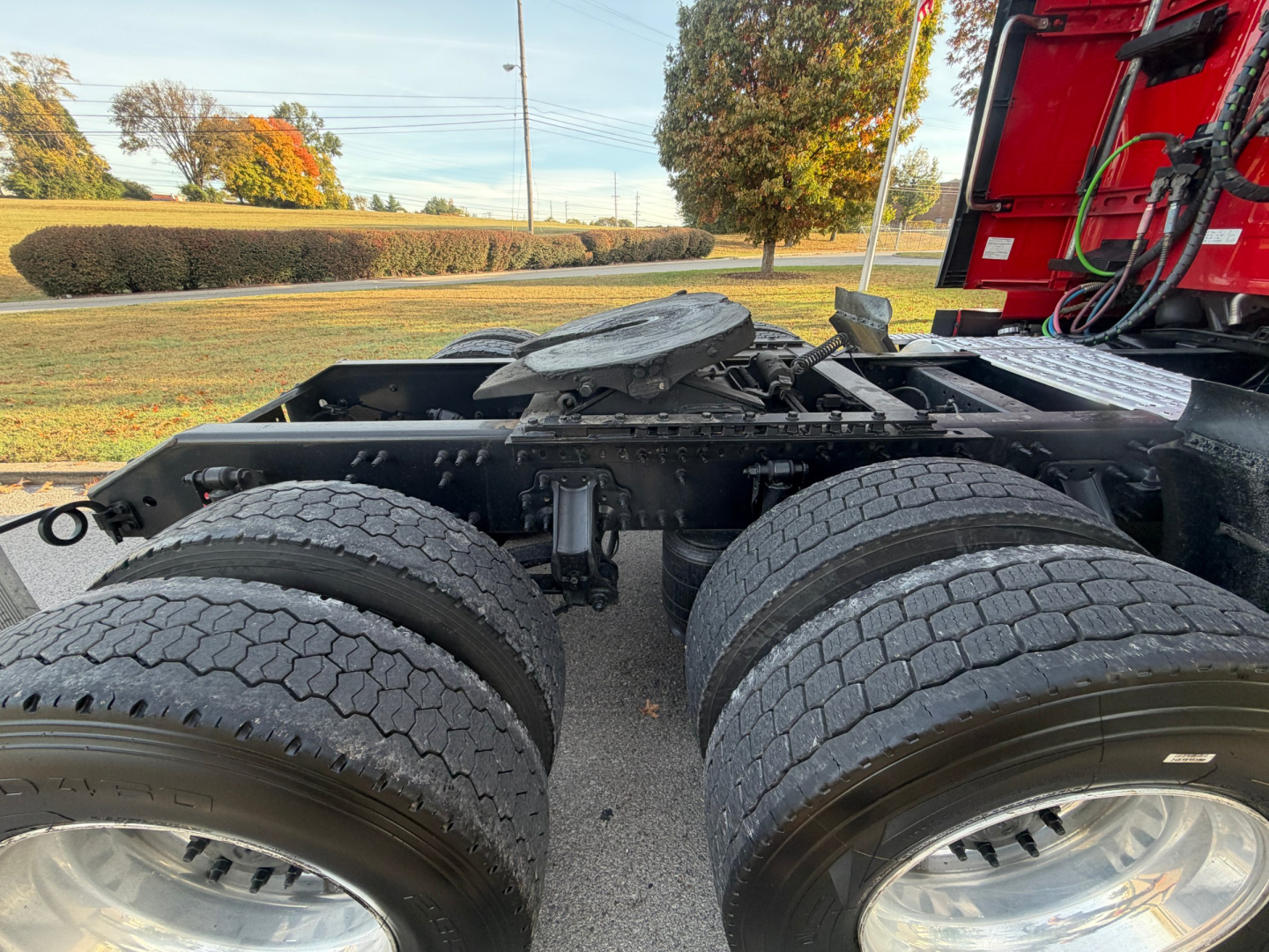 Volvo VNL64T760 truck chassis showing dual rear axles and tires with cab visible on right; engine bay area and frame components visible.