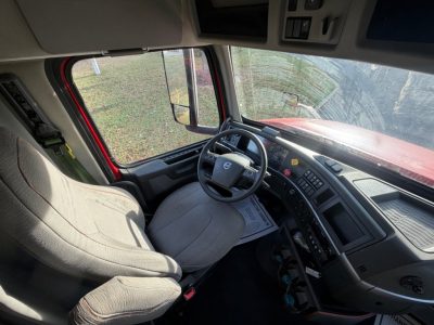 Volvo VNL64T760 truck cab interior showing driver seat, steering wheel, dashboard, and side window