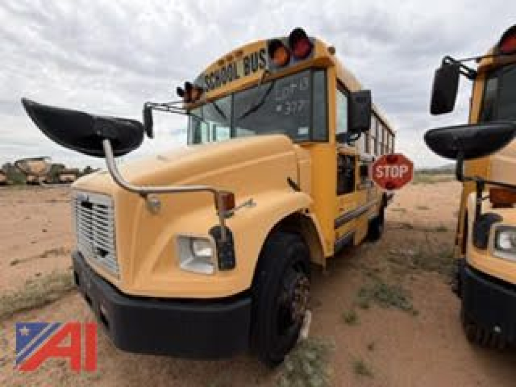 School bus front-left view showing yellow Freightliner FS65 with Stop sign and hood scoop.