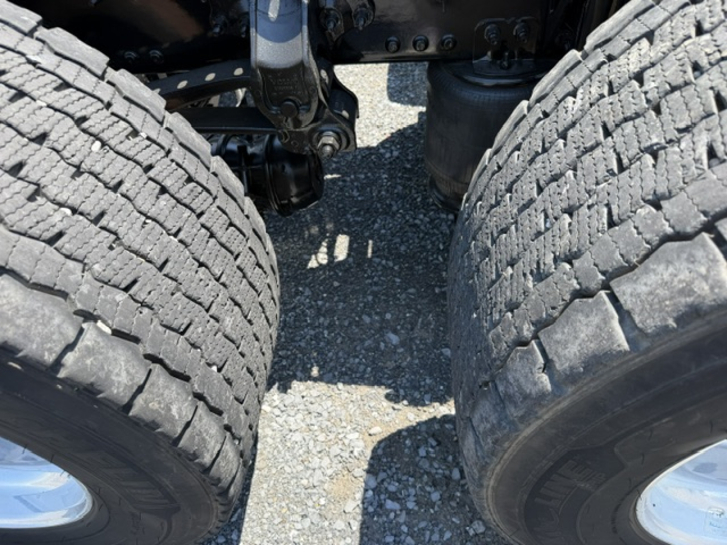Volvo VNL64T300 truck dual rear wheels showing tires and suspension components in view
