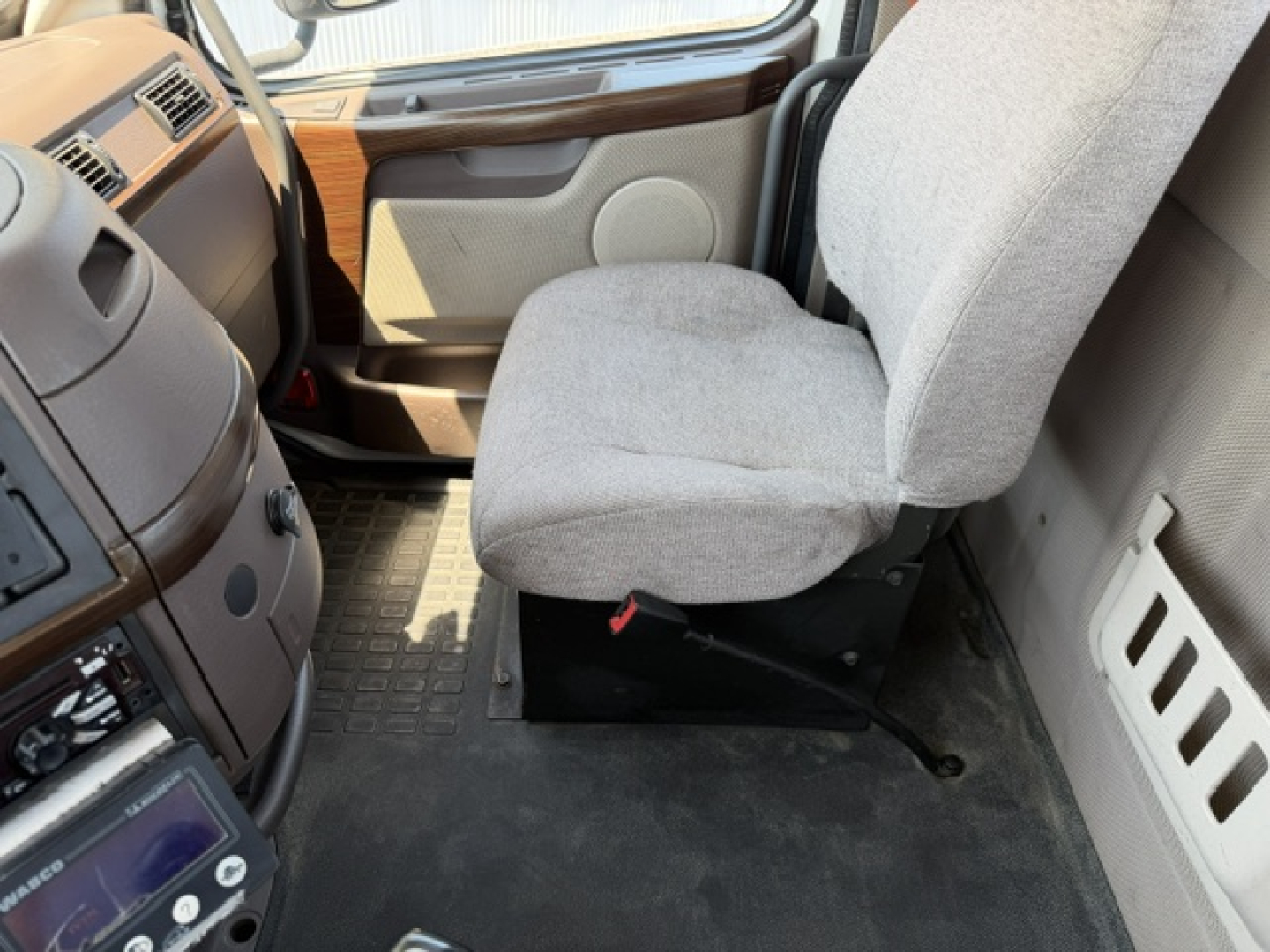 Interior cabin of a 2016 Volvo VNL64T300 truck showing driver seat and part of dashboard. Text visible on user-provided image not legible besides general features.
