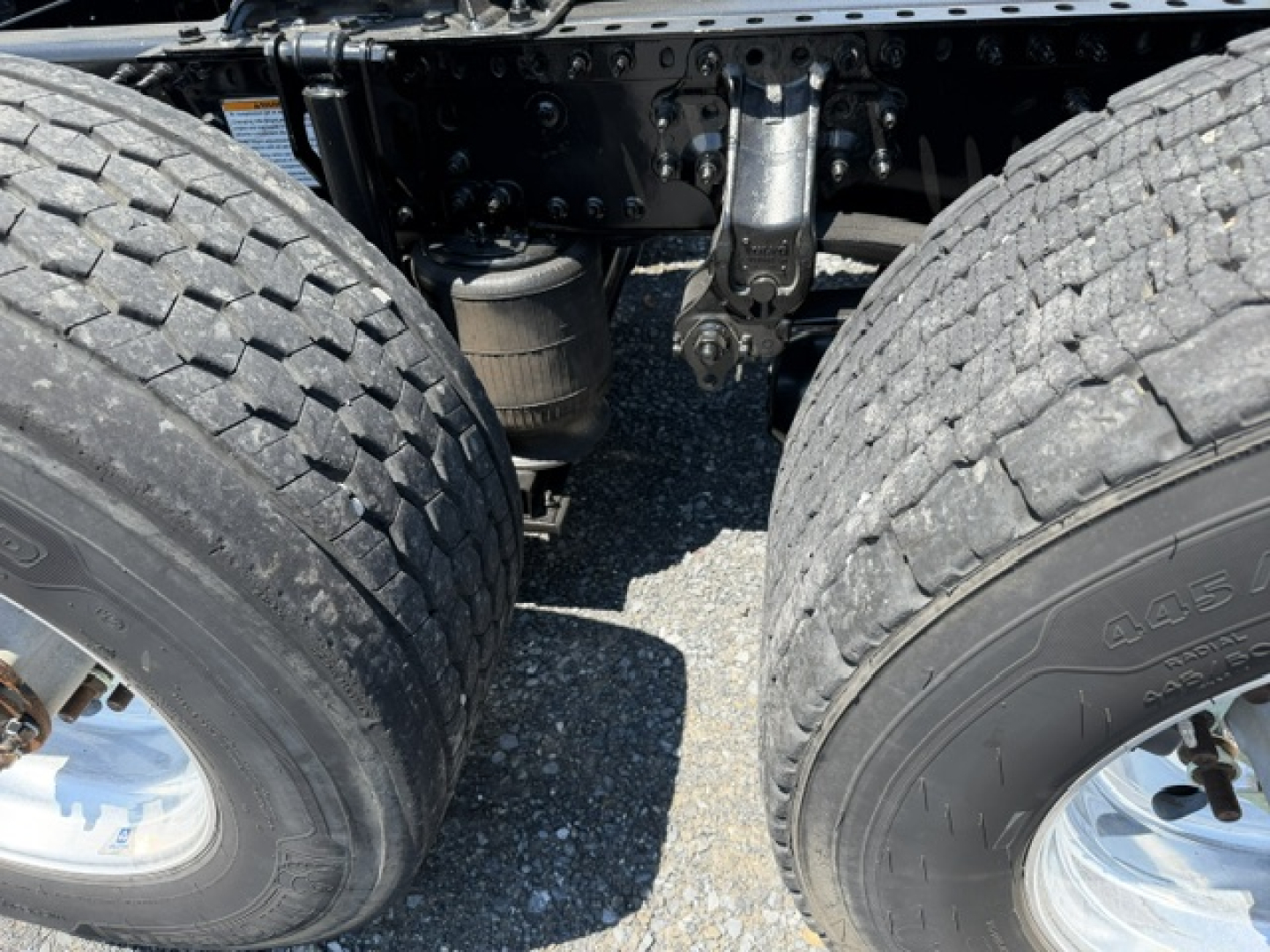 Volvo VNL64T300 truck rear dual wheels and drivetrain components visible, chassis and suspension, no plate text visible.