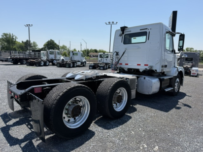 Vehicle: 2016 Volvo VNL64T300 truck in a lot, rear chassis with dual rear axles and fifth wheel, white cab, no visible decals.