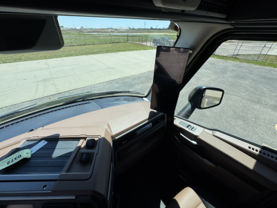 Cab interior of a 2027 Mack PR64T76H truck showing dashboard area and a mounted tablet