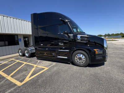 Mack PR64T76H tractor-trailer in black, side view showing sleeper cab and dual rear axles.