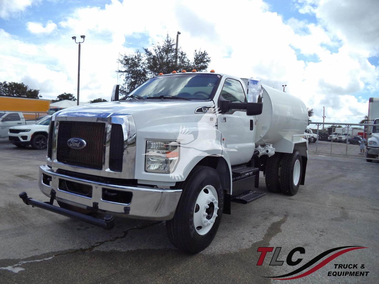 Ford F-650 water tanker truck with white cab and welded steel bumper, side steps, and cylindrical tank visible.