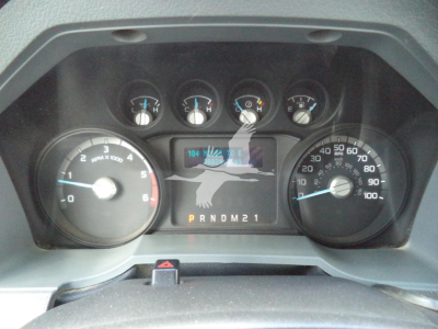 Dashboard of a 2017 Ford F650 truck showing instruments: tachometer left, speedometer right, center display with odometer and gear indicator P R N D M 2 1, warning lights at top.