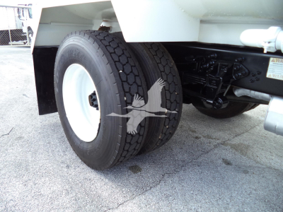 Truck rear wheels and suspension showing dual tires on Ford F650 chassis with undercarriage components.