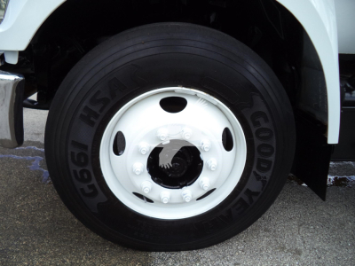 Wheel and tire close-up on a Ford F650 truck showing Goodyear tire and white steel wheel.