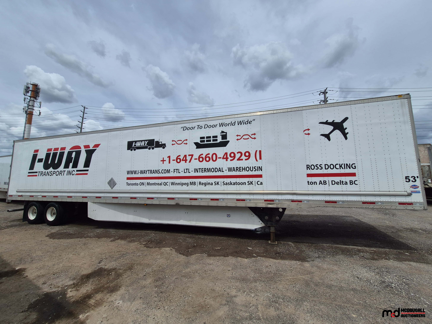 53' dry van trailer side view showing company graphics and logo, VIN tag area not legible, details of text along the trailer