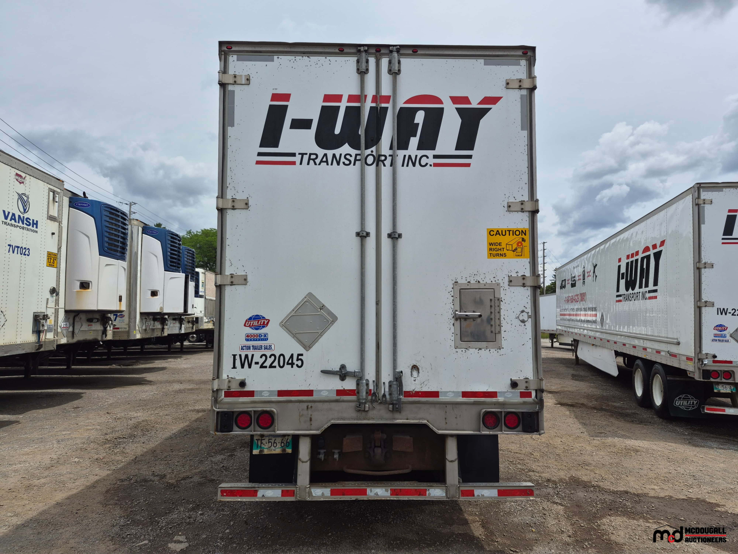 i-Trip i-UNY Transport Inc. logo on rear door of a white 53' dry van trailer, with taillights, bumper, and a caution sticker.