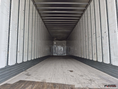 Trailer interior view of a 53' dry van trailer with empty cargo area, wooden floor and metal side walls.