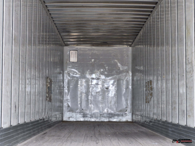Trailer interior showing metal walls, worn floor, and a rear wall with a vent at left; utility 53' dry van trailer interior view