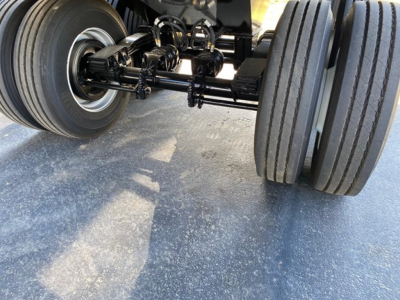 Trailer axle assembly showing dual rearmost wheels and suspension components under a new CPS AR450 trailer.