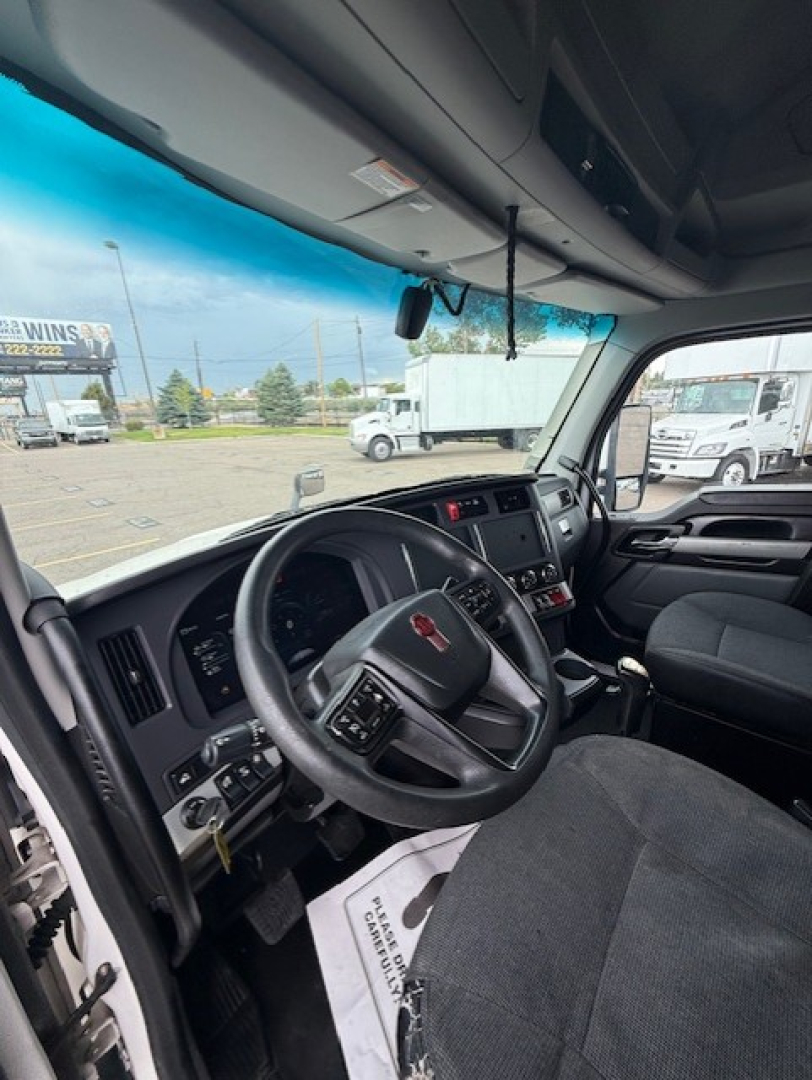 Kenworth T680 dashboard interior view with steering wheel, instrument cluster, and center console in a sleeper cab truck.