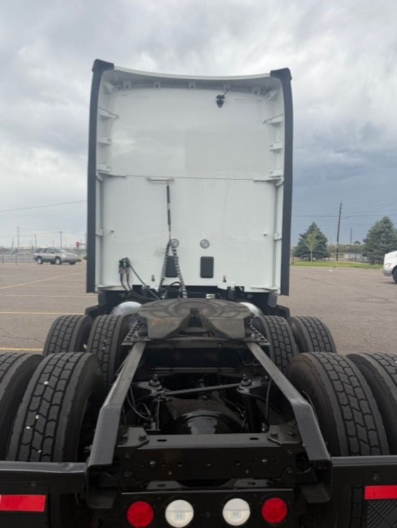 Kenworth truck chassis and fifth wheel area with rear cab and dual rear axles visible; no legible text on components.