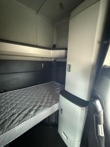 Kenworth T680 sleeper cab interior showing bunk bed and cabinetry