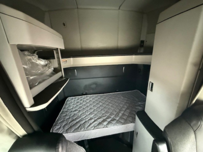 Kenworth T680 sleeper cab interior showing bunk bed with mattress and storage compartments