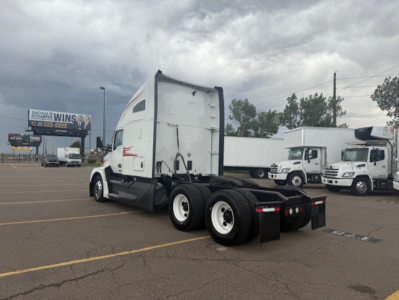 Kenworth T680 truck tractor rear view showing triple axle and white sleeper cab