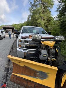 Front view of a 2017 Chevrolet Silverado 3500HD with a plow attached. The chrome grille and headlights are visible, with a yellow snow plow blade in the foreground.