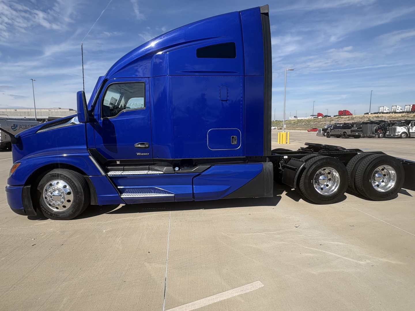 Kenworth T680 truck side view showing blue tractor cab and rear wheels.