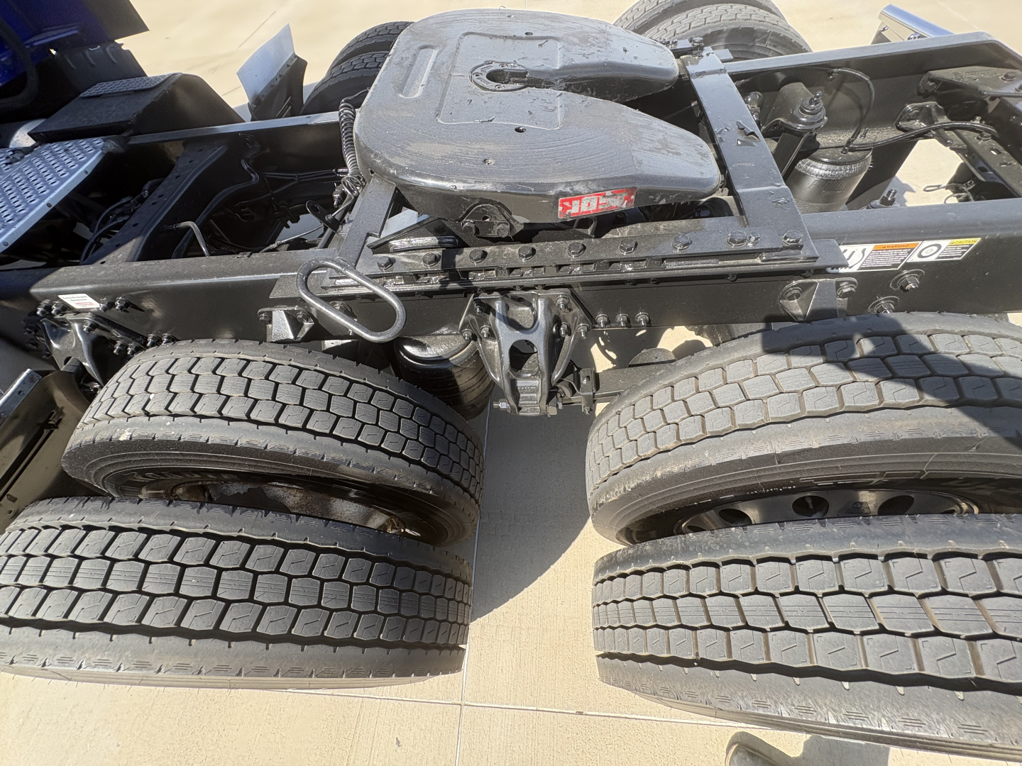 Kenworth T680 chassis showing rear axle and fifth wheel mounting with dual rear axles and tires visible.