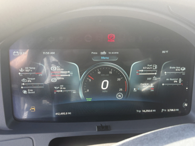 Kenworth T680 digital instrument cluster showing speedometer at 0 mph, trip data, and multiple gauges; a red PARK indicator and various readouts including oil, coolant, DEF, and fuel.