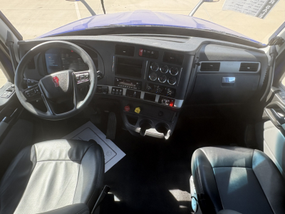 Kenworth T680 truck interior dashboard and steering wheel with control panels and gauges visible.