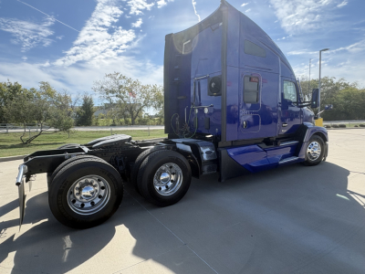 Kenworth T680 tractor cab in blue side view showing rear wheels and sleeper area, no visible text on components.
