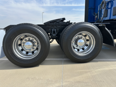 Kenworth T680 dual rear axle wheels with chrome hubcaps and black chassis.