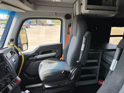 Kenworth T680 interior cab view with driver seat and sleeper area, dashboard visible