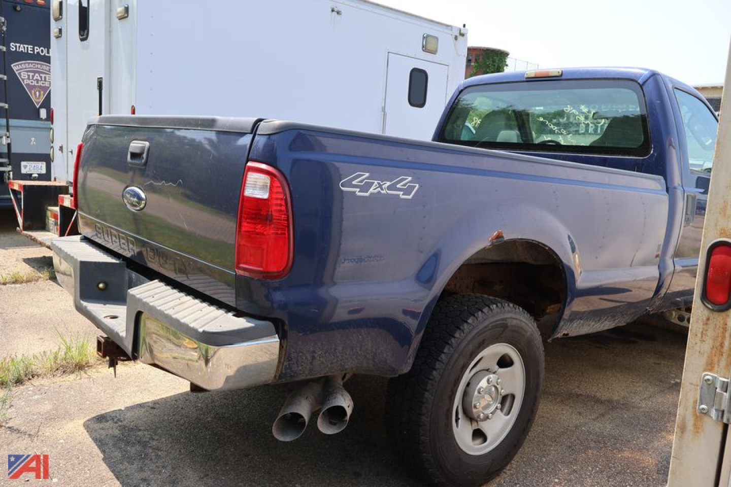 Ford F-350 Super Duty pickup truck rear-left view showing 4x4 badge and dual exhaust
