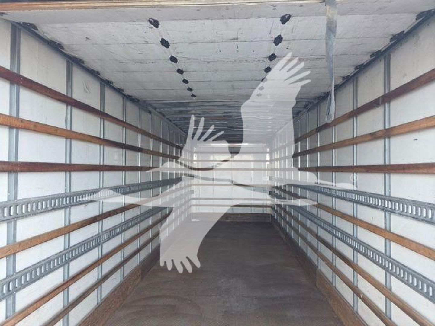Trailer interior showing empty box truck with metal side rails and wooden slats, cargo bay with ceiling lights visible.