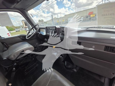 Cab interior of a 2020 International MV truck showing steering wheel, dashboard, driver seat, and front passenger area.