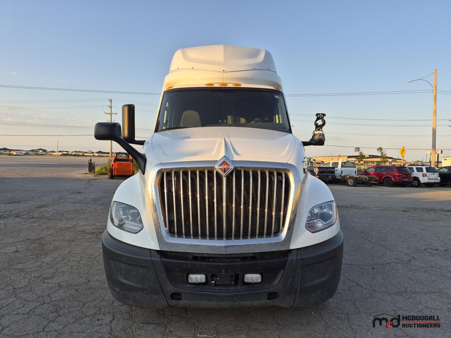 Truck front view showing International LT625 sleeper cab with chrome vertical grille, large bumper, and dual headlights.