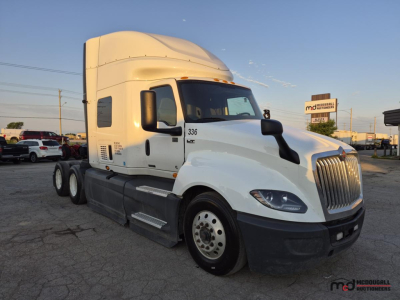 Truck cab side view of a 2021 International LT625 T/A Sleeper showing front grille and sleeper cab area.