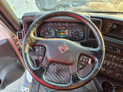 Truck cockpit steering wheel with instrument cluster and center display, interior of a semi truck