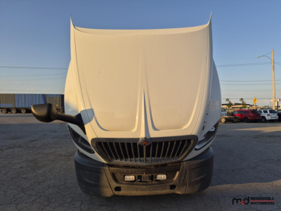 Truck hood open showing International LT series cab with grill and front bumper, no text visible.