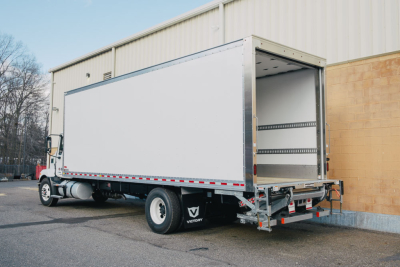 Box truck rear and side view showing cargo area and rear doors with open access, Mack MD6 in-service vehicle.