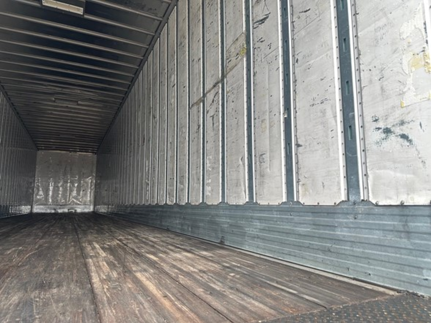Trailer interior showing metal sidewalls and wooden floor in a Utility 4000Dx trailer.