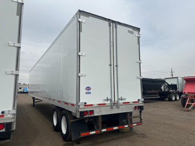 Trailer rear view showing double doors, utility 4000Dx trailer with white exterior and black tires.