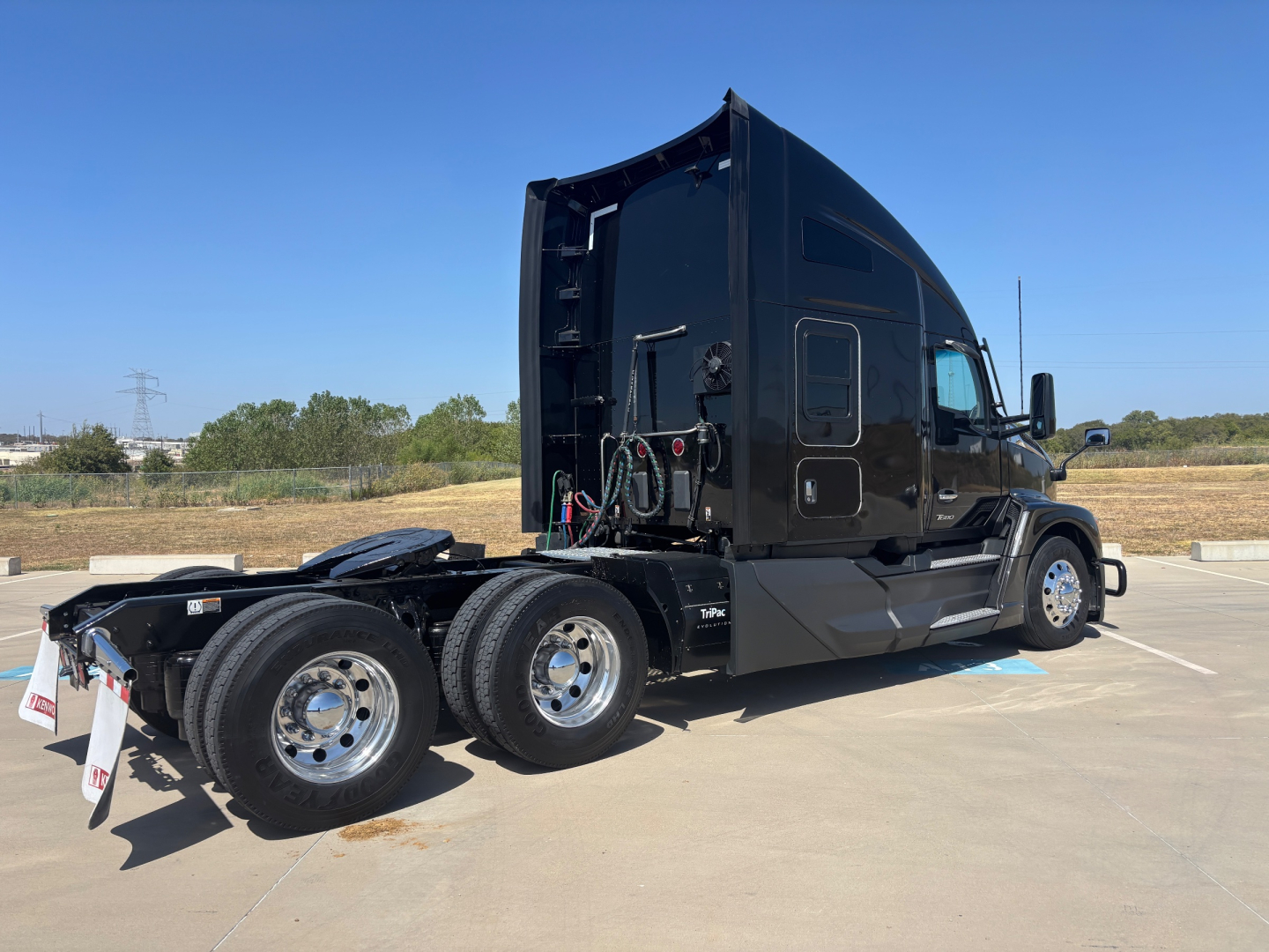 Kenworth T680 tractor in semi-truck sleeper cab configuration with black exterior, side view, dual rear axles and visible fifth-wheel area.