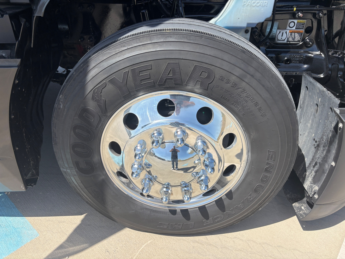 Kenworth T680 wheel close-up showing Goodyear endur tire and chrome hub with lug nuts.