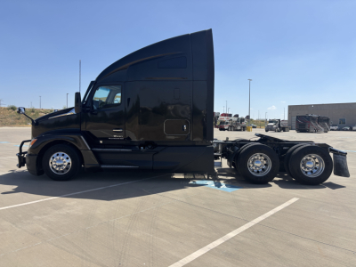 Kenworth T680 truck side view showing cabin and chassis without trailer, in a parking lot.