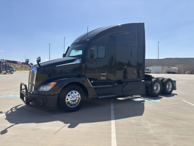 Kenworth T680 truck in black, side view showing sleeper cab with dual rear axles and chrome wheels.