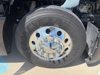 Kenworth T680 wheel close-up showing Goodyear endur tire and chrome hub with lug nuts.
