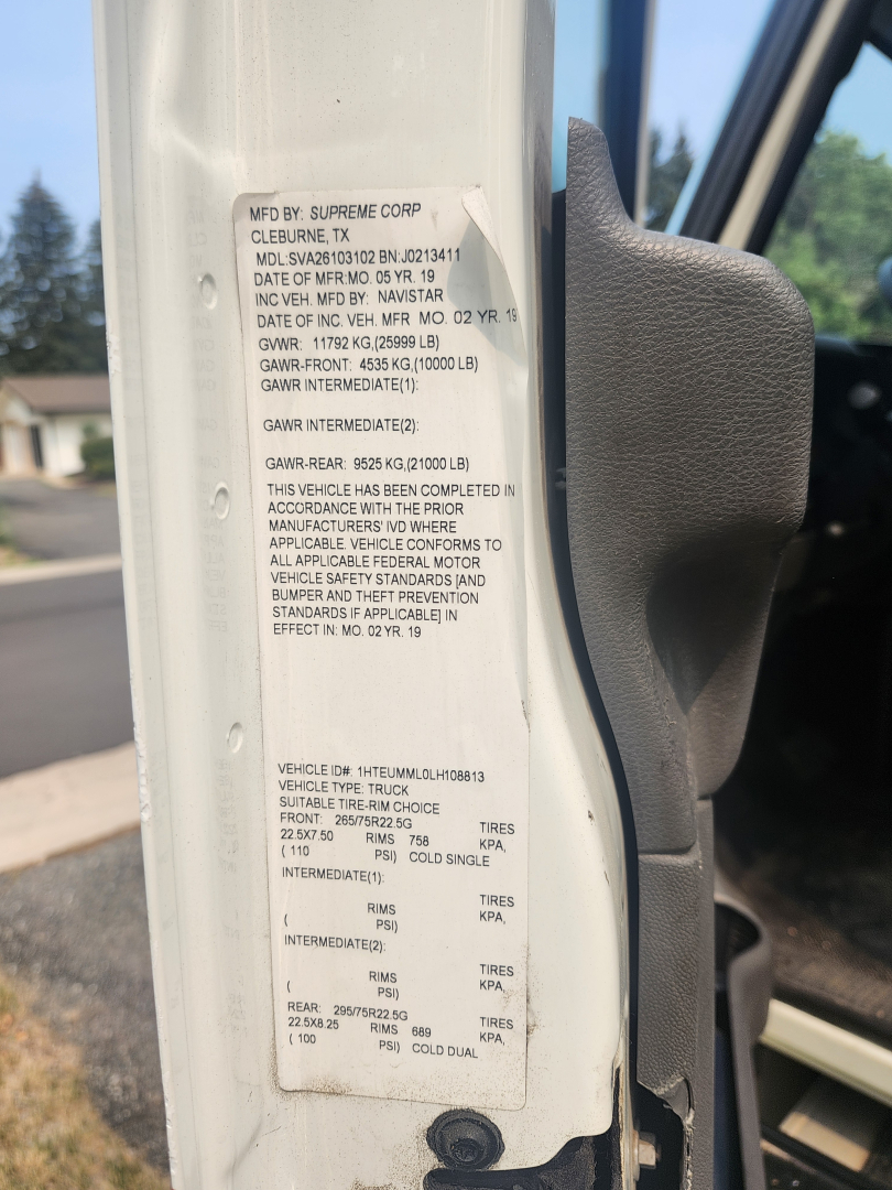 MFD BY SUPREME CORP CLERVUNE TX plate with VIN and vehicle data; date codes, GVWR, GAWR, tire specs, and compliance text visible on door jamb