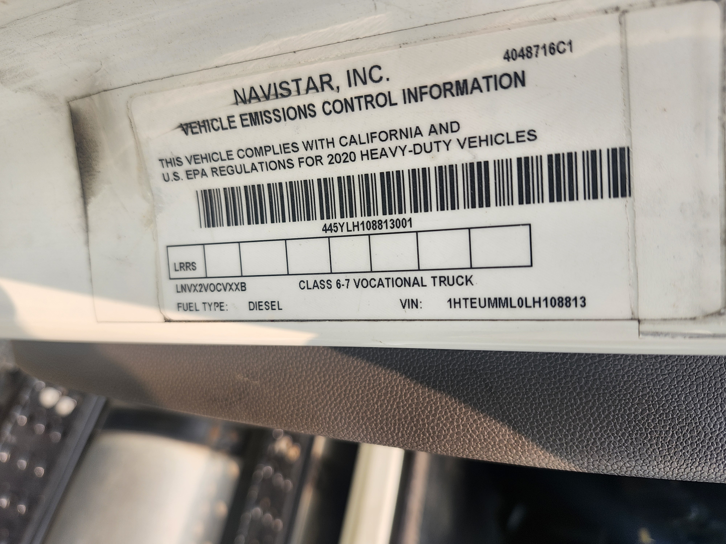 Vehicle emissions control information label on a Navistar truck, showing VIN 1HTEUMML0LH108813, Class 6-7 vocational truck, fuel type Diesel, sticker with barcode.